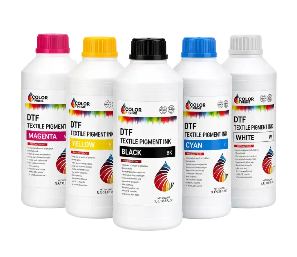 CMYK and white DTF textile pigment ink bottles used for professional DTF film printing service in Jeddah to produce vibrant and durable fabric prints.
