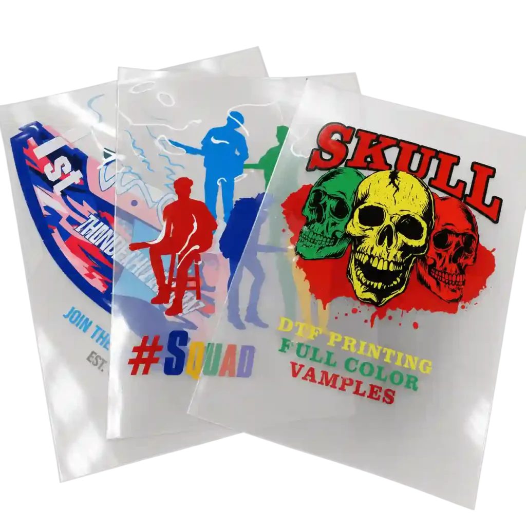 Printed DTF transfer sheets with colorful sample designs.