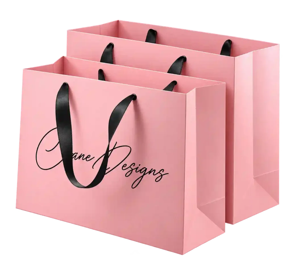 Pink custom printed paper gift bags with rope handles.